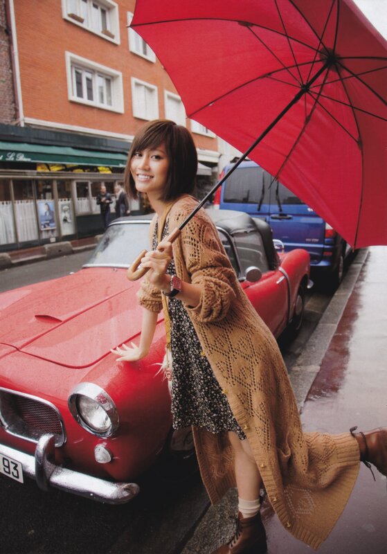 Woman with red umbrella and car