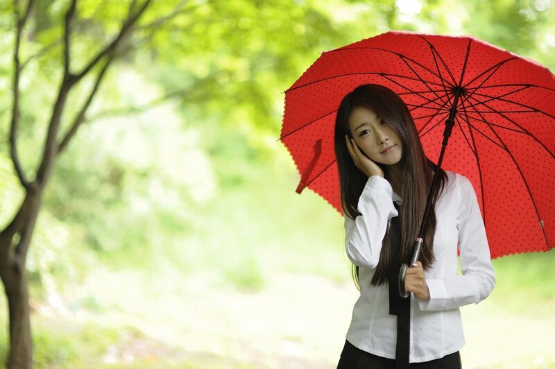 woman with red umbrella in park