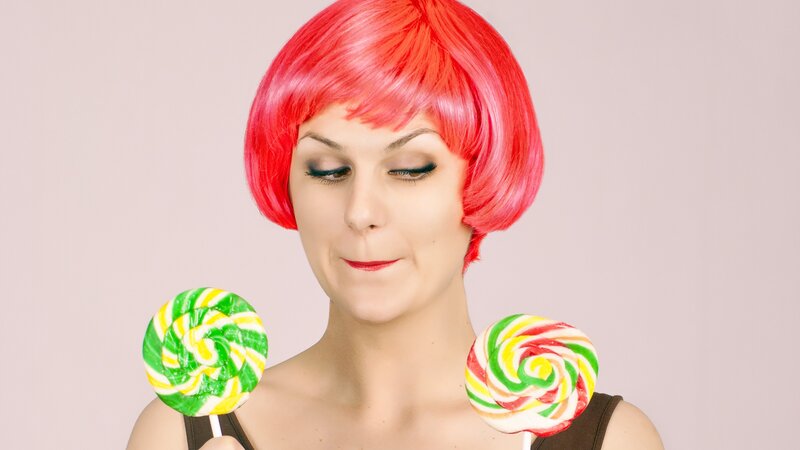 woman with red wig and lollipops