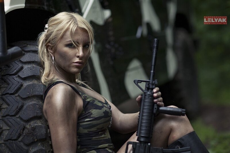 woman with rifle in camouflage