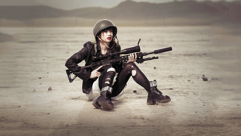 woman with rifle in desert