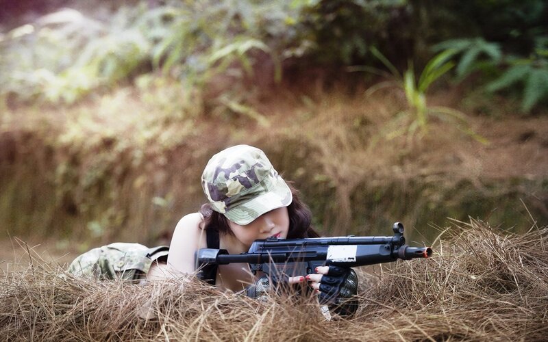 Woman with Rifle in Grass — Green