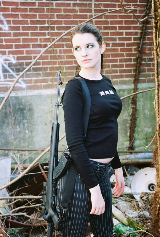 Woman with rifle in urban setting