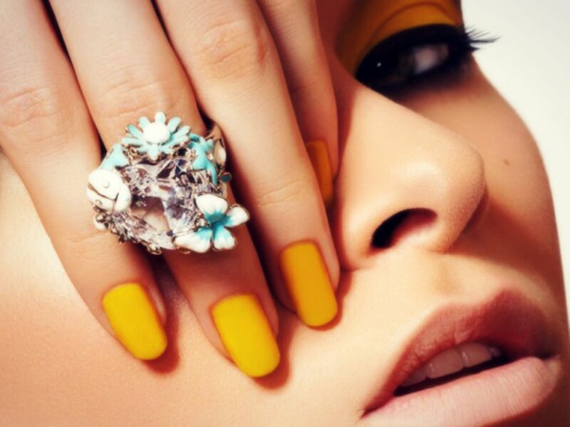 Woman with Ring and Yellow Nails