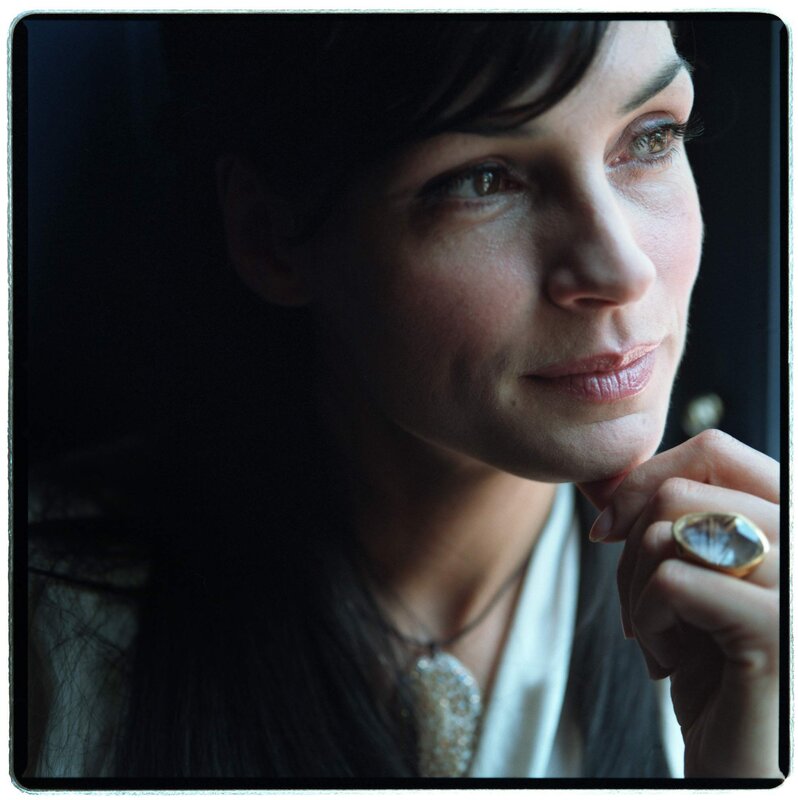 woman with ring looking out window