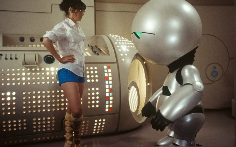 Woman with robot in control room