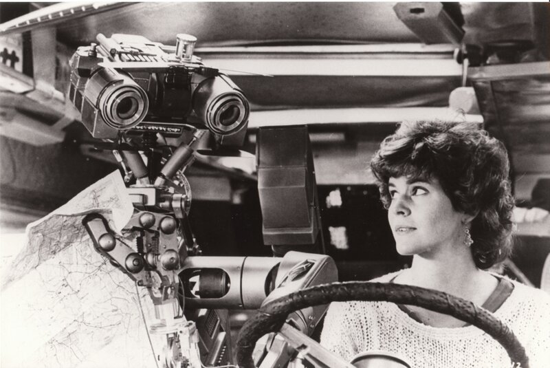Woman with robot in vehicle