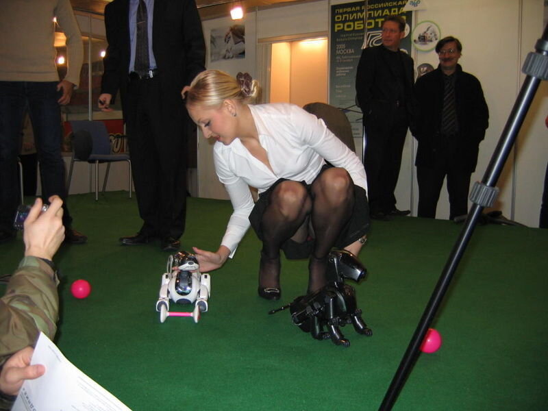 Woman with robots at exhibition