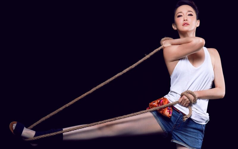 woman with rope on dark background