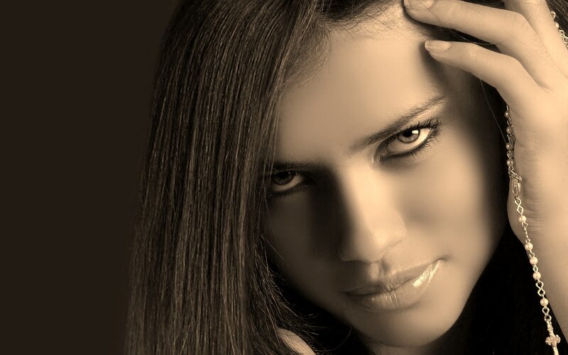 woman with rosary in sepia