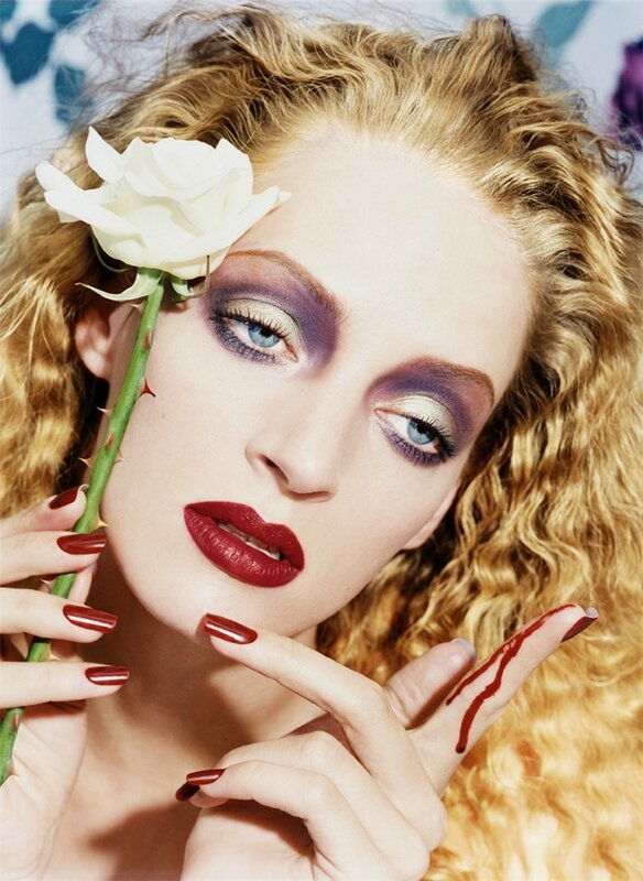 Woman with rose and dramatic makeup