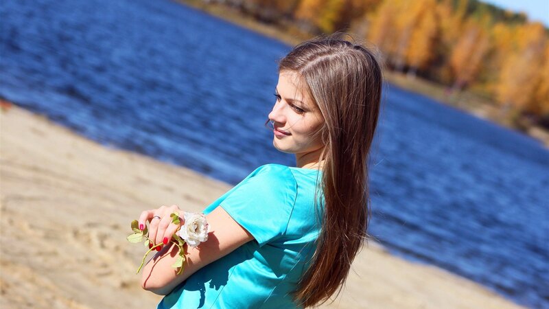 Woman with rose by the lake
