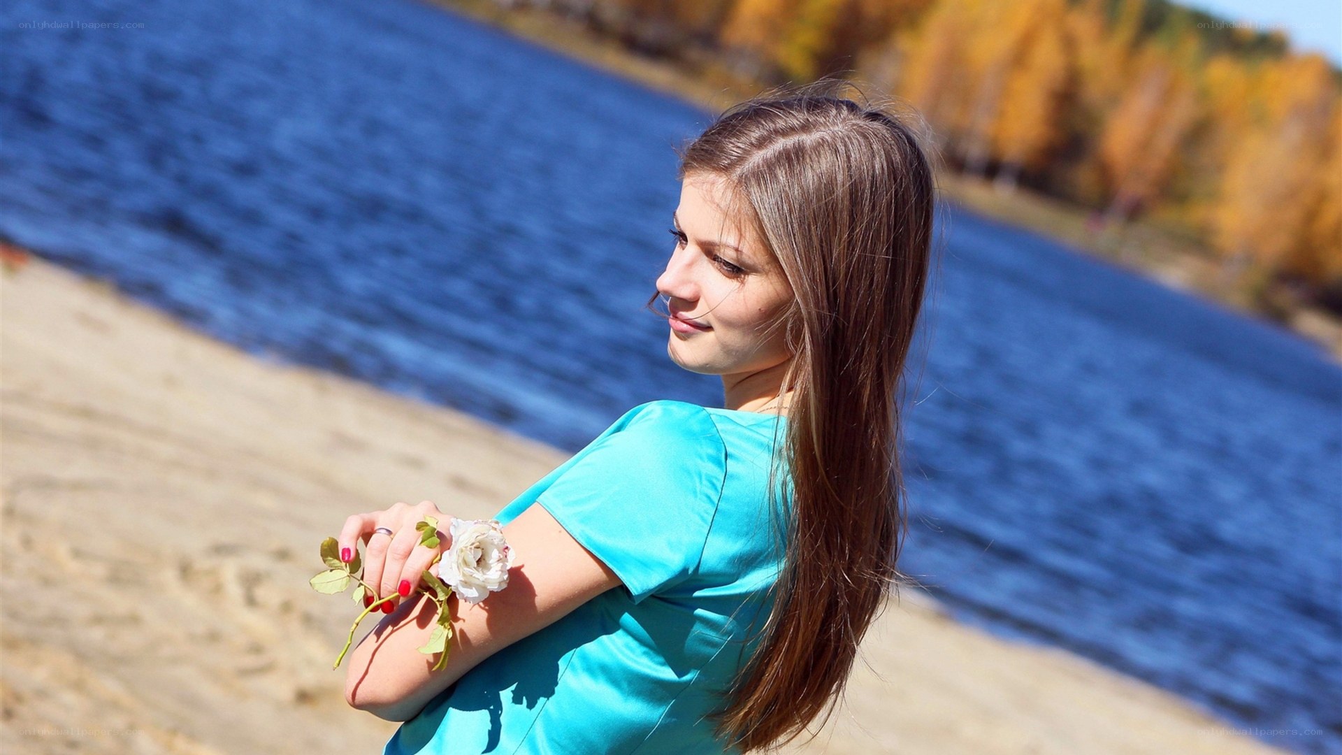 Woman with rose by the lake