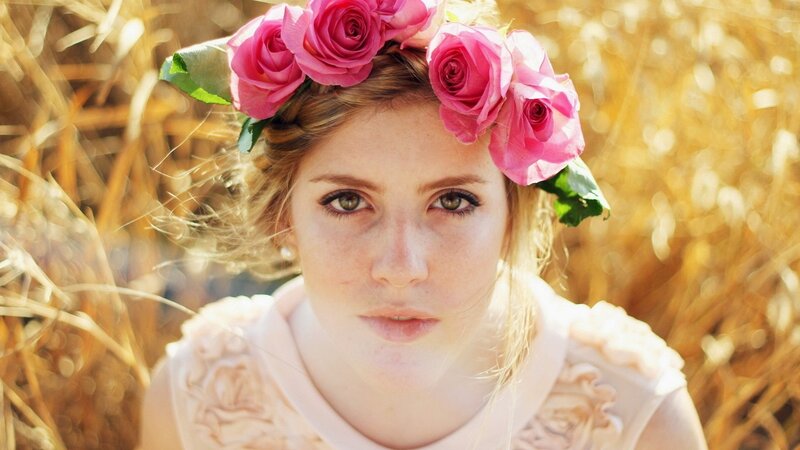 woman with rose crown in field