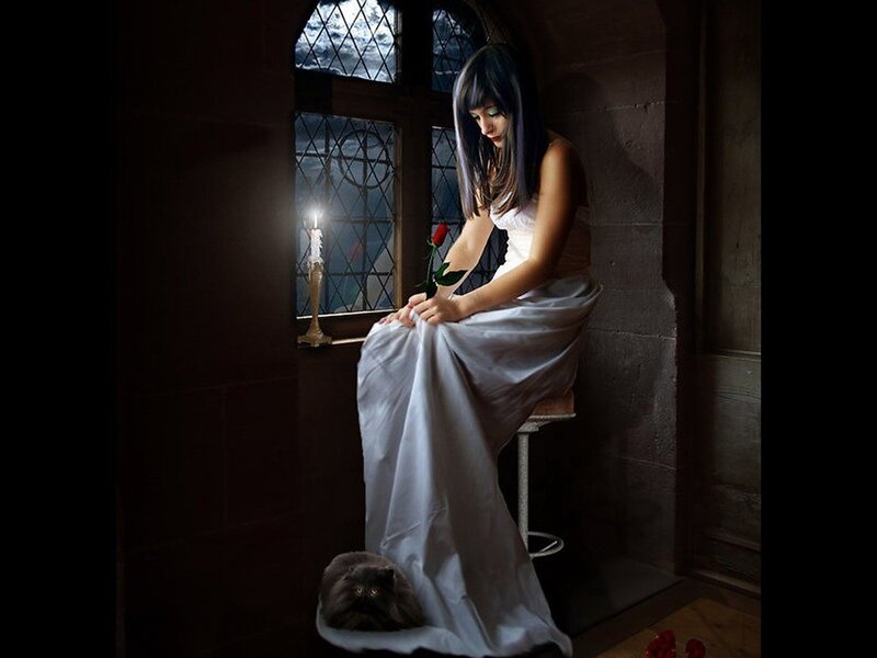 woman with rose in dim room