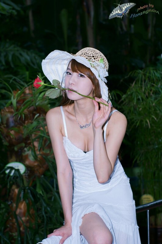 Woman with rose in garden