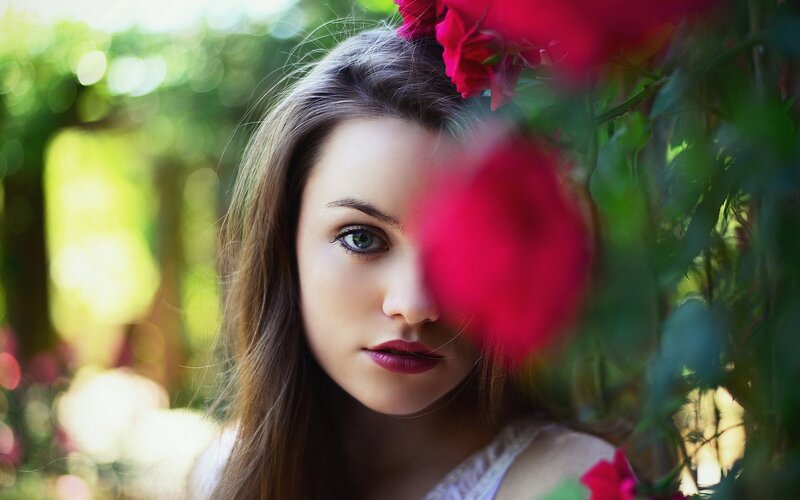 woman with rose in garden