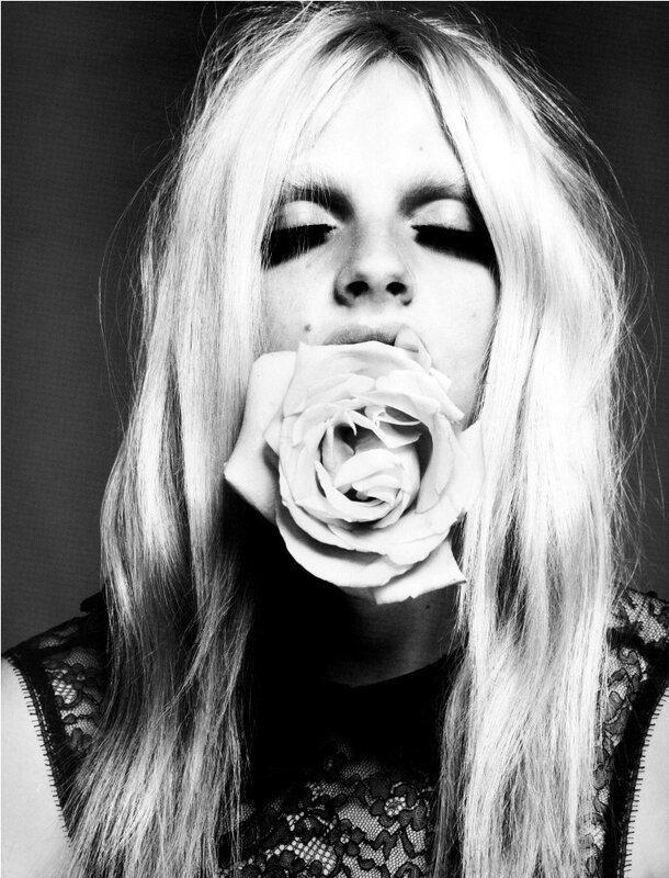 woman with rose in mouth