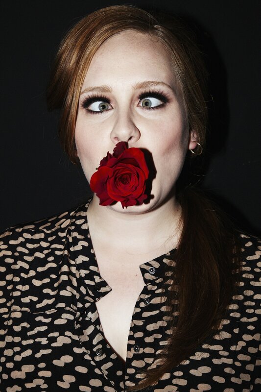 Woman with rose in mouth