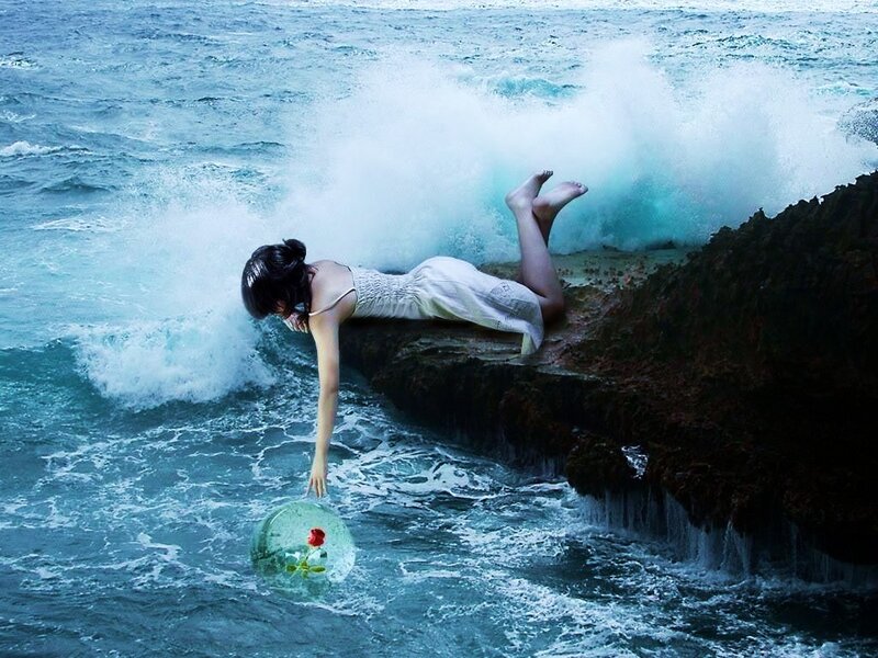 woman with rose in ocean