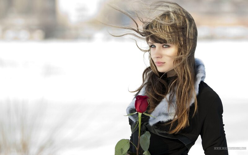 woman with rose in snow