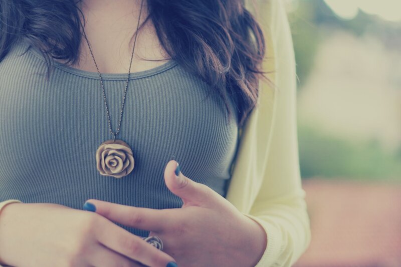 woman with rose pendant