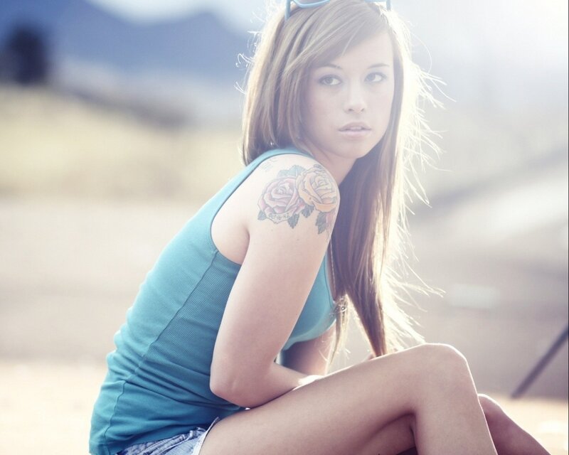 woman with rose tattoo outdoors