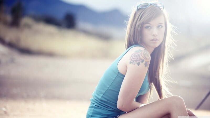 woman with rose tattoo outdoors