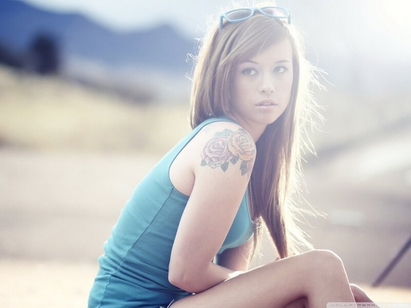 woman with rose tattoo outdoors