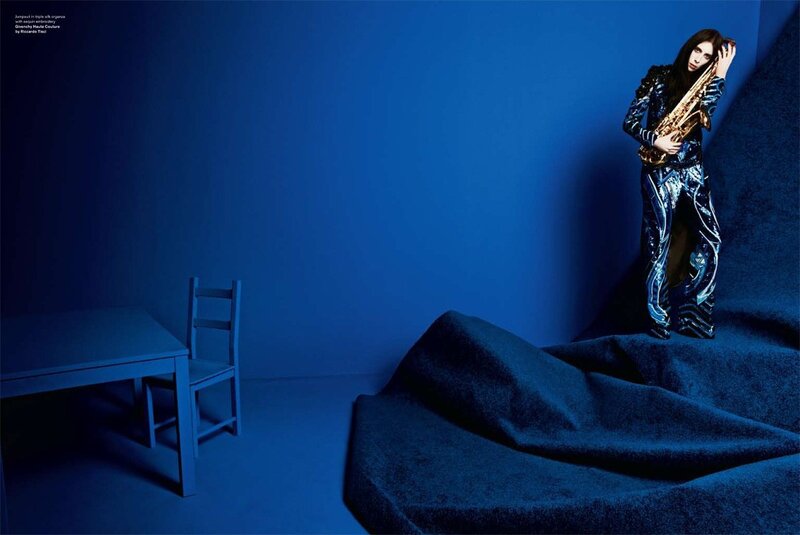 woman with saxophone in blue room