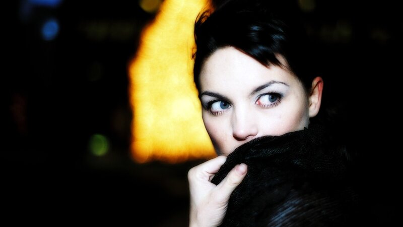 woman with scarf at night