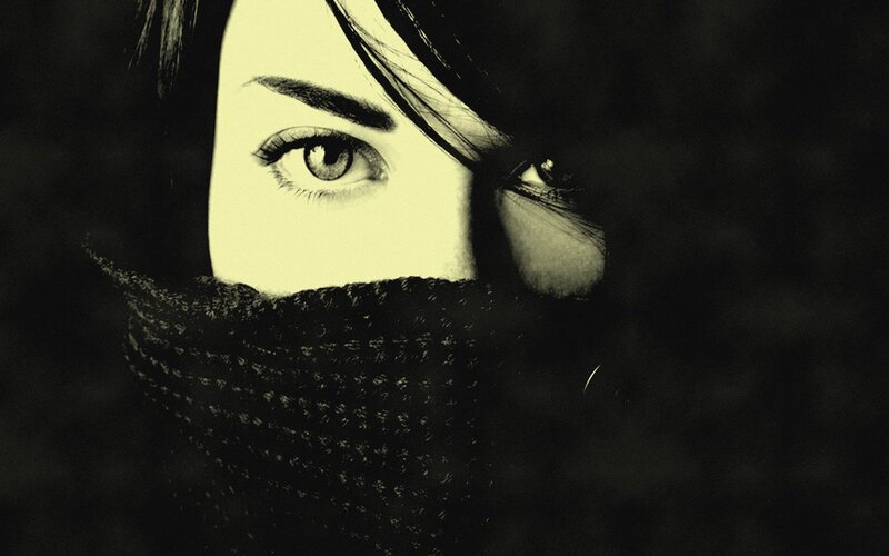 woman with scarf covering face