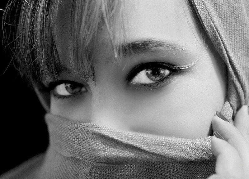 woman with scarf covering face