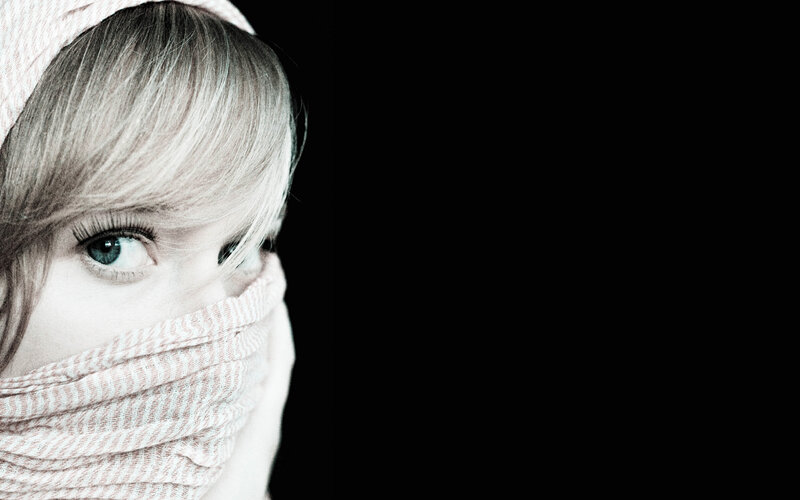woman with scarf covering face