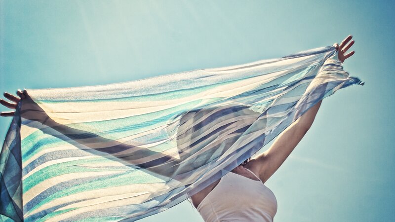 woman with scarf in sky