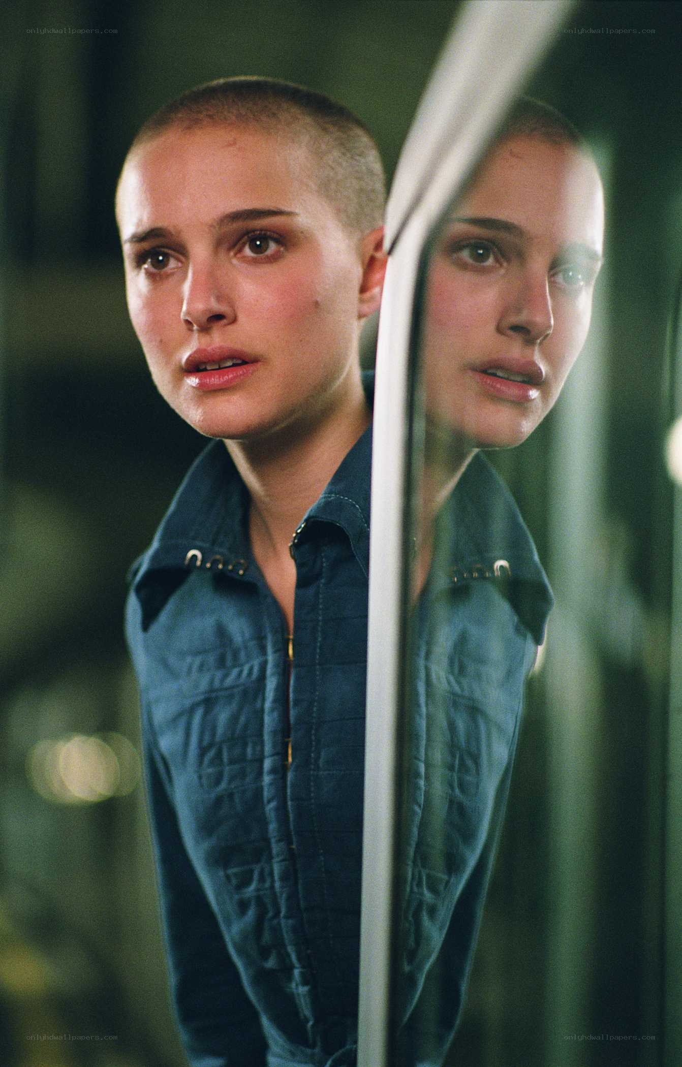 woman with shaved head in reflection