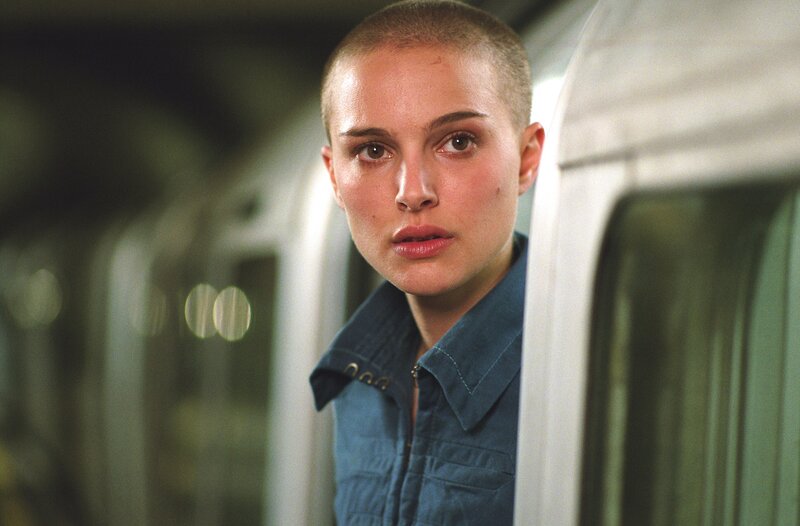 woman with shaved head in subway