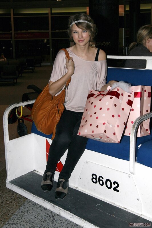 woman with shopping bags at airport