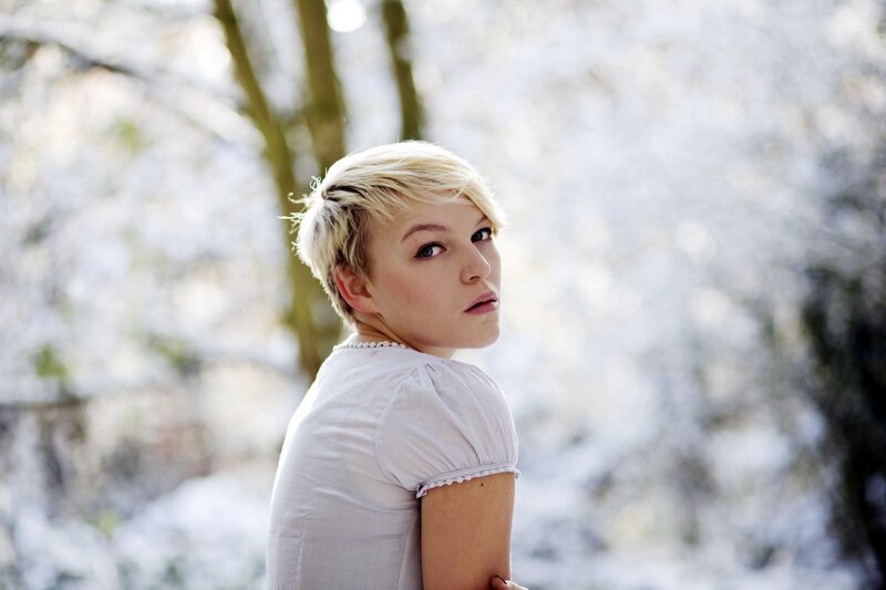 woman with short blonde hair in winter