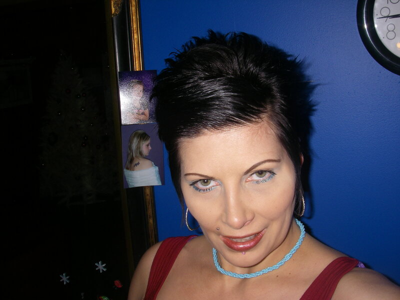 woman with short hair and blue necklace