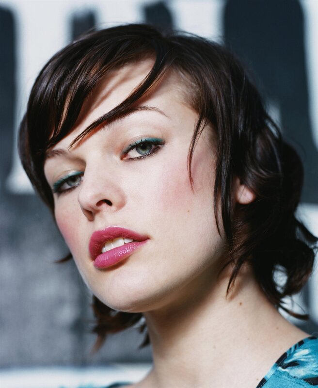 woman with short hair and colorful makeup