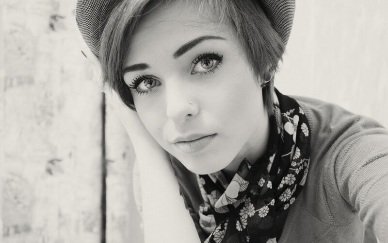 woman with short hair and hat
