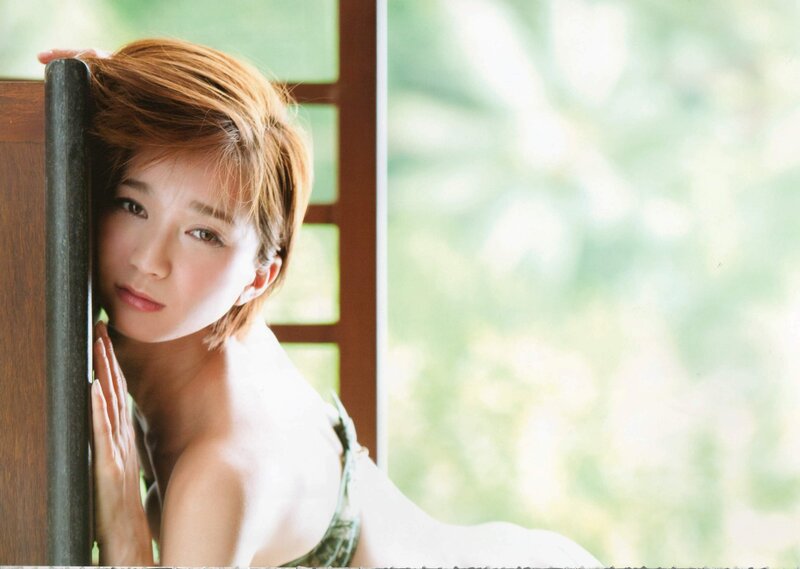 woman with short hair by window