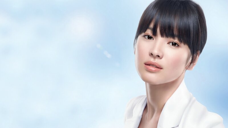 woman with short hair in white coat