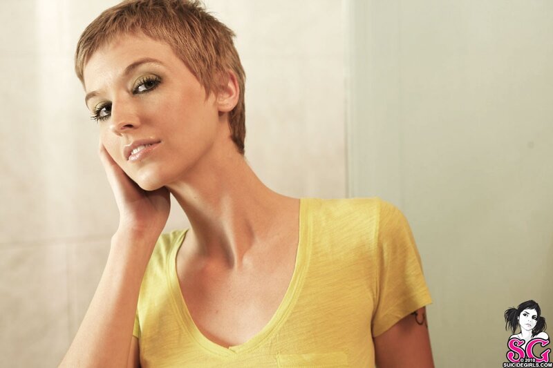 woman with short hair in yellow shirt