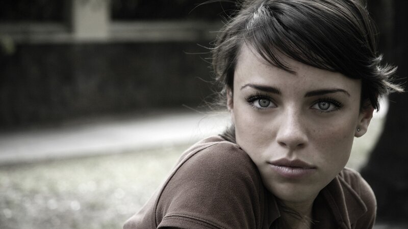 woman with short hair looking at camera