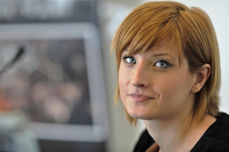 woman with short hair looking at camera
