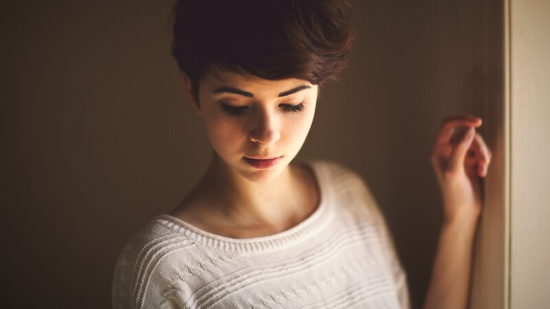 woman with short hair looking down
