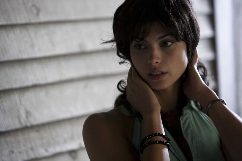 woman with short hair looking thoughtful