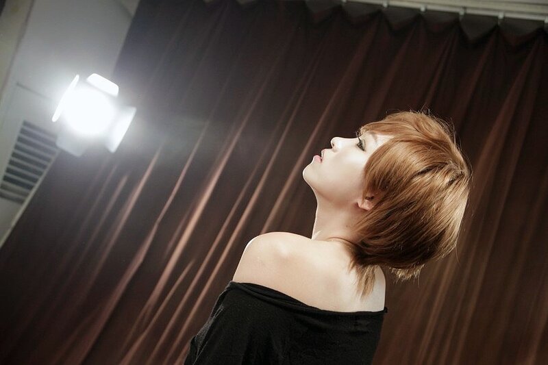 woman with short hair looking up